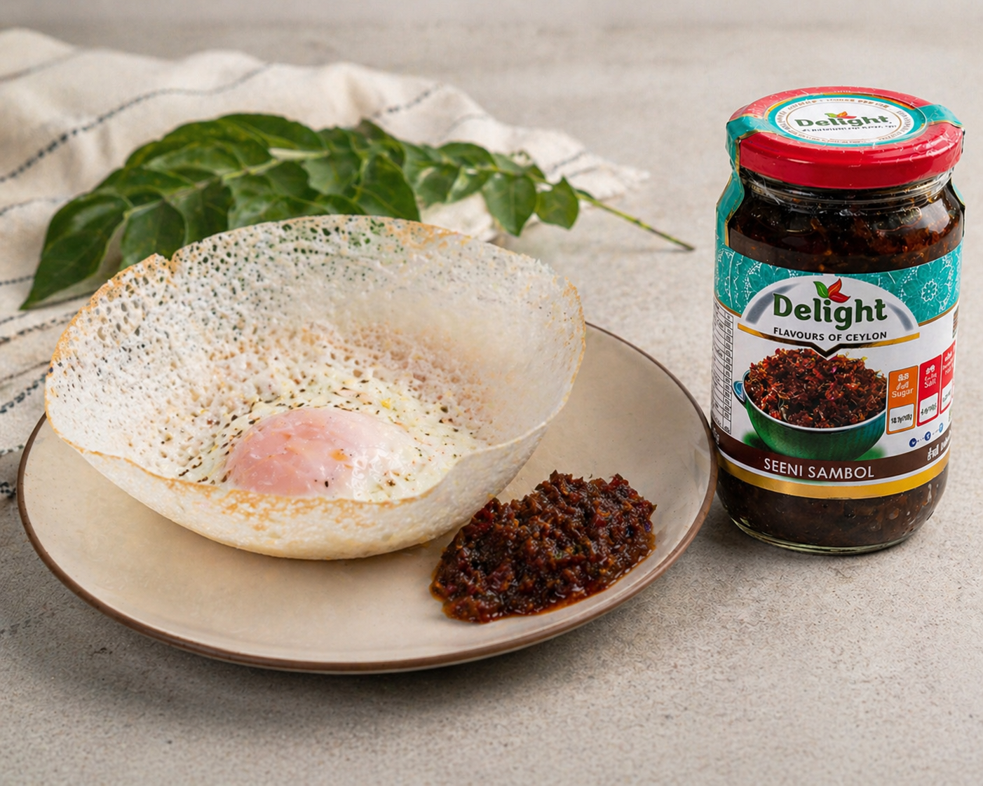 A jar of Seeni Sambol next to a plate with egg hoppers and seeni sambol serveed with it. A classic sri lankan pairing. 